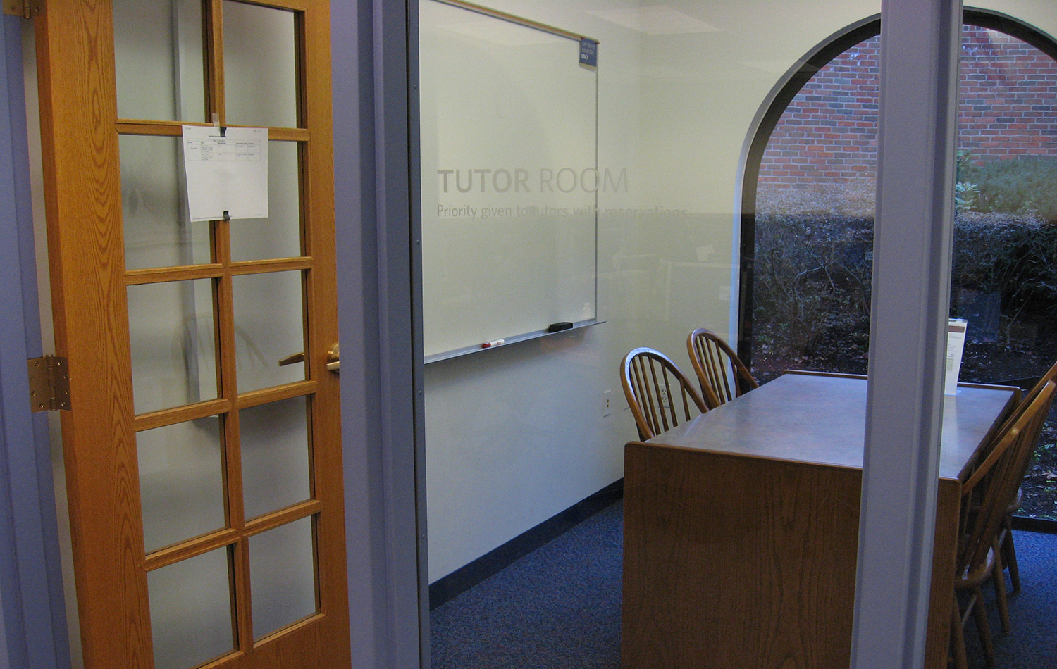View of the Chipmunk Study Room equipped with a table, chairs, and white board